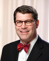 Man wearing glasses and a bow tie.