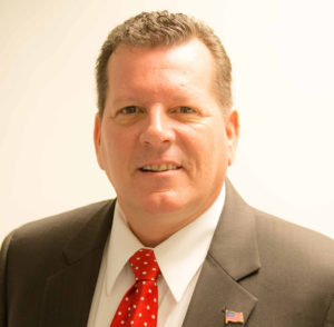 Man in suit with red polka dot tie.
