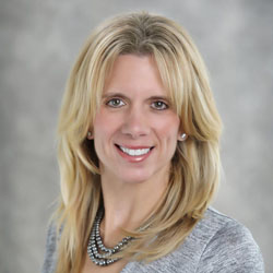 Portrait of smiling woman with blonde hair.